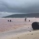 Children play in the contaminated red waters of Kangava Bay.